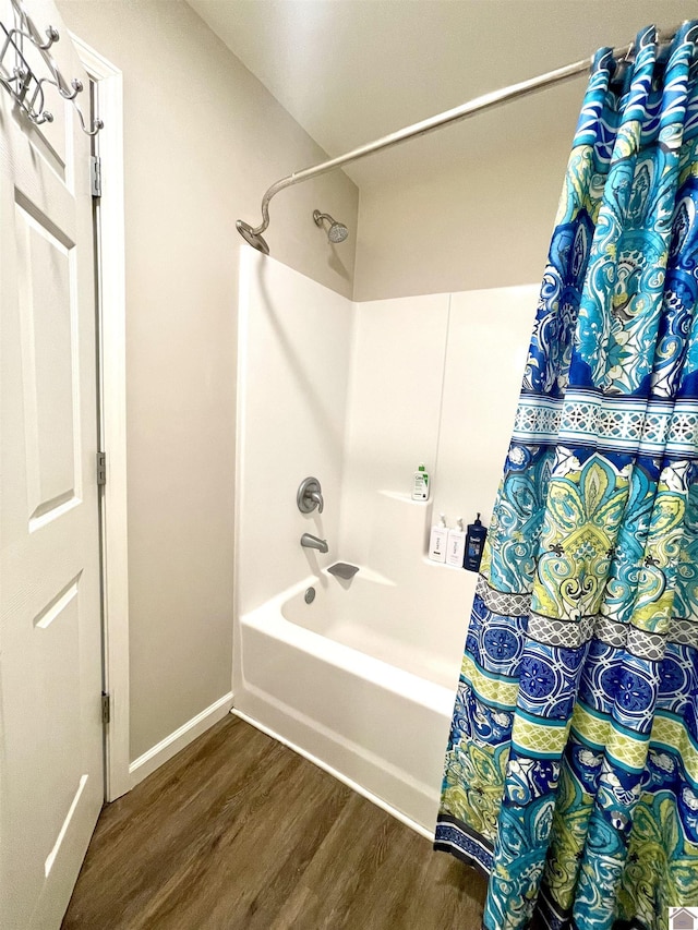 1783 Radio Rd, Almo, KY 42020 - full bathroom with wood finished floors, shower / bath combo with shower curtain, and baseboards