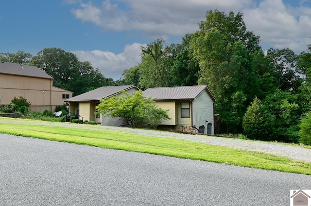 250 Jan Ann Dr, Paducah, KY 42003 - view of front facade with metal roof, a front lawn, and stone siding