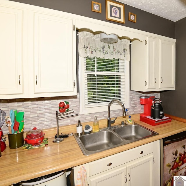 250 Jan Ann Dr, Paducah, KY 42003 - kitchen with a sink, decorative backsplash, light countertops, and white cabinetry