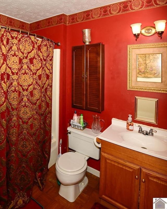 250 Jan Ann Dr, Paducah, KY 42003 - bathroom with vanity, toilet, a textured ceiling, shower / bath combo with shower curtain, and baseboards
