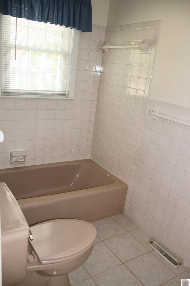 156 Albany, Paducah, KY 42003 - bathroom featuring tile walls, a tub to relax in, tile patterned floors, and toilet