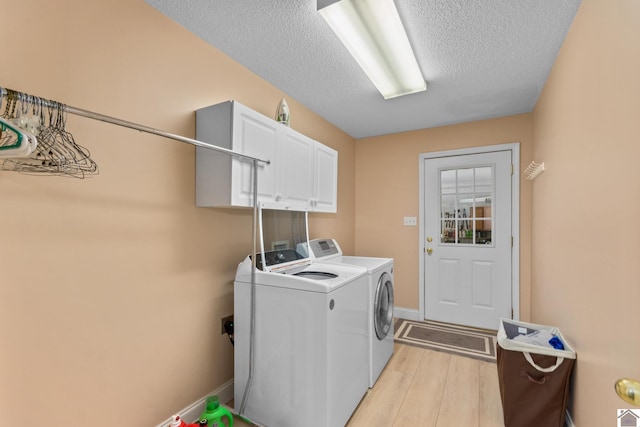 68 Lazy K Ln, Kuttawa, KY 42055 - laundry room with independent washer and dryer, cabinet space, light wood-style flooring, a textured ceiling, and baseboards