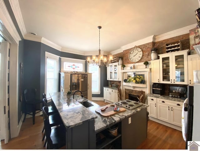 1722 Jefferson St, Paducah, KY 42001 - dining space featuring a chandelier, wood finished floors, crown molding, and a fireplace