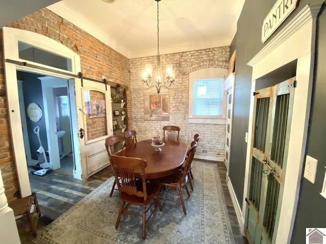 1722 Jefferson St, Paducah, KY 42001 - dining area with brick wall, a barn door, dark wood-type flooring, a chandelier, and crown molding