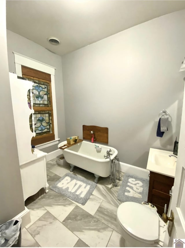 1722 Jefferson St, Paducah, KY 42001 - bathroom with vanity, a soaking tub, toilet, marble finish flooring, and baseboards