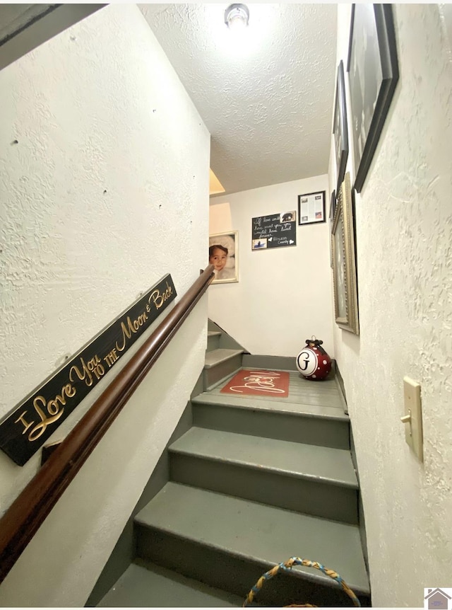 1722 Jefferson St, Paducah, KY 42001 - stairs with a textured ceiling and a textured wall