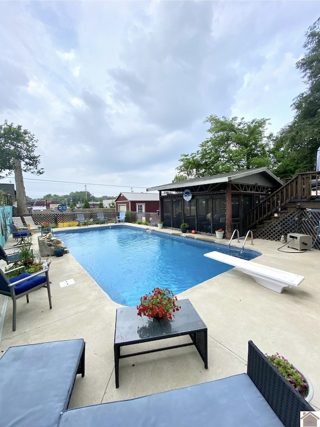 1722 Jefferson St, Paducah, KY 42001 - view of swimming pool featuring a diving board, a patio area, a sunroom, and stairway
