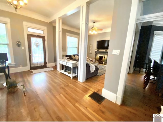 1722 Jefferson St, Paducah, KY 42001 - entrance foyer with a fireplace with raised hearth, wood finished floors, and plenty of natural light