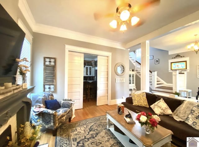 1722 Jefferson St, Paducah, KY 42001 - living area featuring stairway, wood finished floors, a ceiling fan, crown molding, and baseboards
