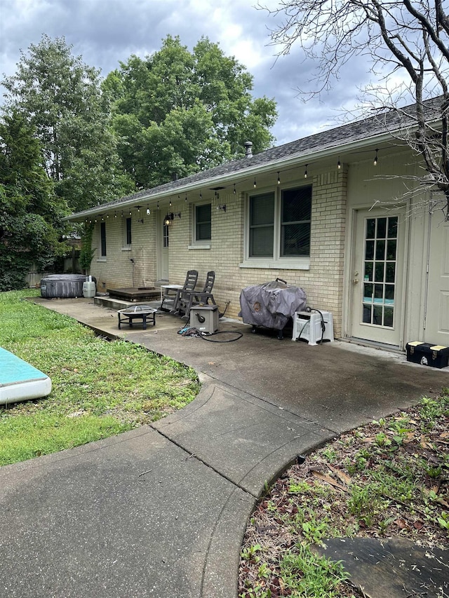 260 Riverside Dr, Paducah, KY 42003 - back of property featuring a patio area, brick siding, a shingled roof, and a lawn