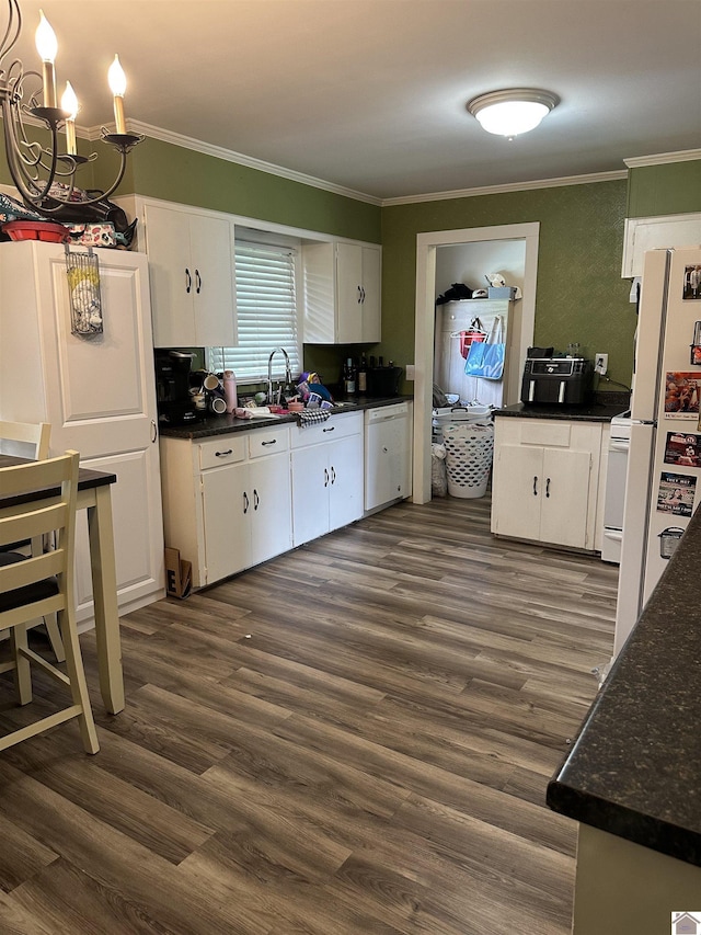 260 Riverside Dr, Paducah, KY 42003 - kitchen featuring dark countertops, crown molding, white appliances, and white cabinetry