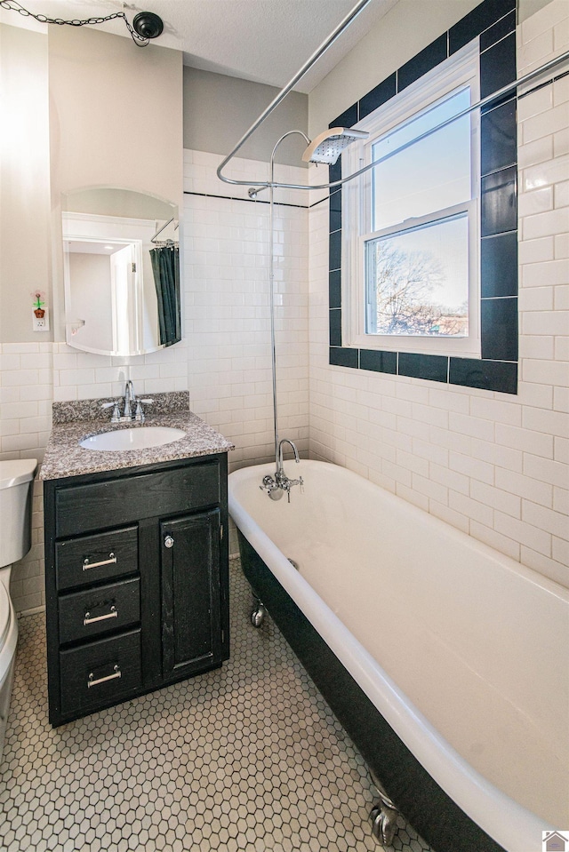 620 Madison St, Paducah, KY 42001 - bathroom featuring toilet, tile walls, vanity, and shower / bath combination with curtain