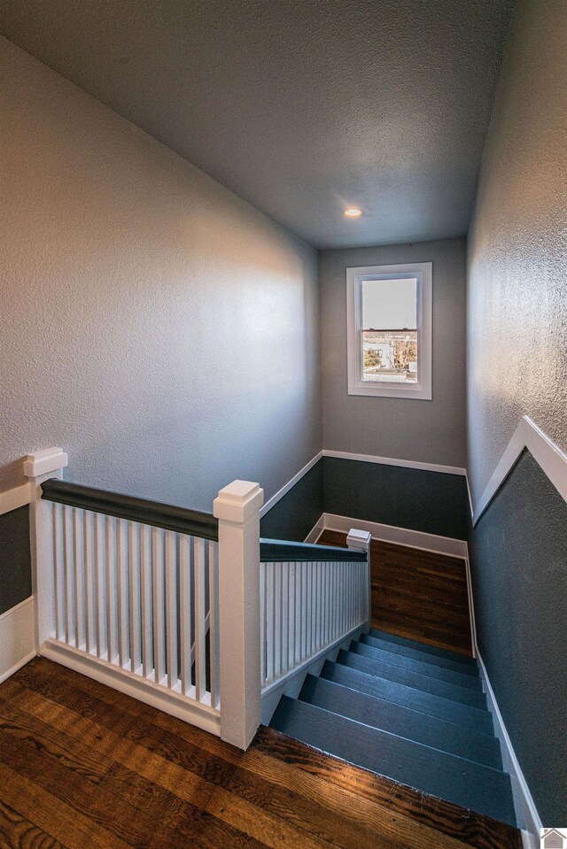 620 Madison St, Paducah, KY 42001 - staircase with wood finished floors, a textured wall, baseboards, and a textured ceiling