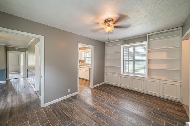9740 Crotzer Rd, West Paducah, KY 42086 - spare room featuring ceiling fan, dark wood-type flooring, baseboards, and a textured ceiling
