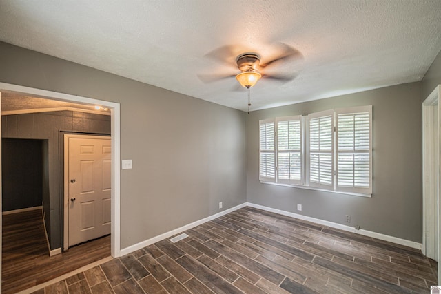 9740 Crotzer Rd, West Paducah, KY 42086 - spare room featuring baseboards, ceiling fan, dark wood-type flooring, and a textured ceiling