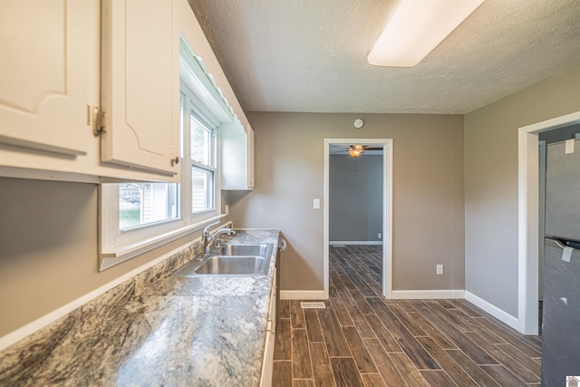 9740 Crotzer Rd, West Paducah, KY 42086 - kitchen with a sink, a textured ceiling, baseboards, dark wood-style flooring, and a ceiling fan