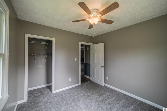 9740 Crotzer Rd, West Paducah, KY 42086 - unfurnished bedroom featuring baseboards, a textured ceiling, carpet, a closet, and ceiling fan