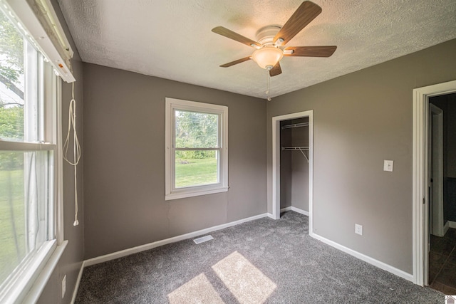 9740 Crotzer Rd, West Paducah, KY 42086 - unfurnished bedroom with a textured ceiling, baseboards, carpet, a closet, and ceiling fan