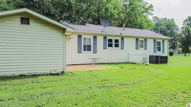 9740 Crotzer Rd, West Paducah, KY 42086 - back of property with a yard and central air condition unit