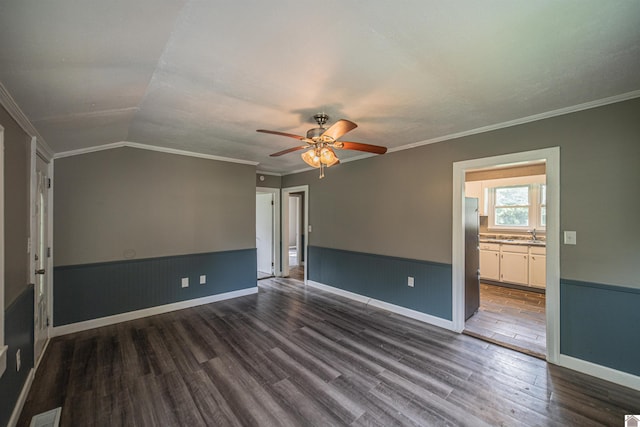 9740 Crotzer Rd, West Paducah, KY 42086 - empty room with dark wood-type flooring, ceiling fan, vaulted ceiling, a sink, and crown molding