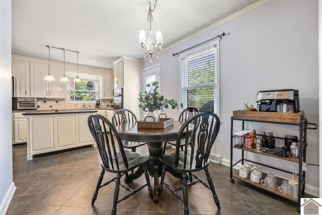 1310 Hilltop Dr, Mayfield, KY 42066 - dining area with healthy amount of natural light, track lighting, a chandelier, crown molding, and baseboards