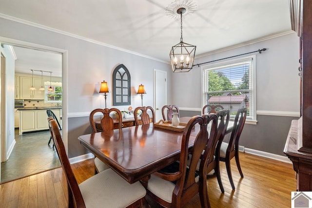 1310 Hilltop Dr, Mayfield, KY 42066 - dining area with a chandelier, wood-type flooring, healthy amount of natural light, baseboards, and ornamental molding