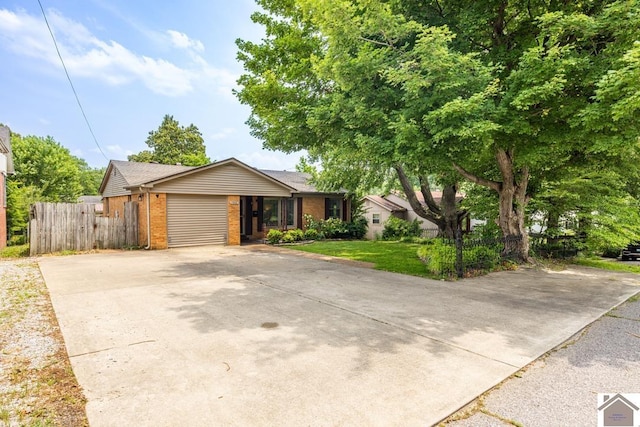 1310 Hilltop Dr, Mayfield, KY 42066 - view of front facade with concrete driveway, brick siding, and a garage