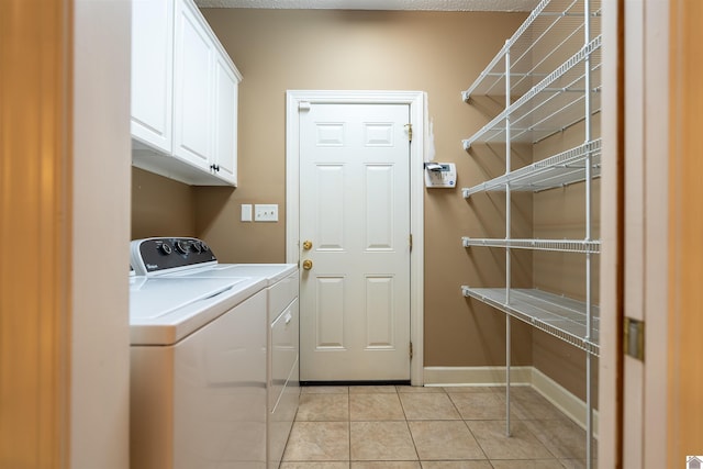 2492 Lakewood Dr, Paducah, KY 42003 - washroom with washer and dryer, light tile patterned floors, cabinet space, and baseboards