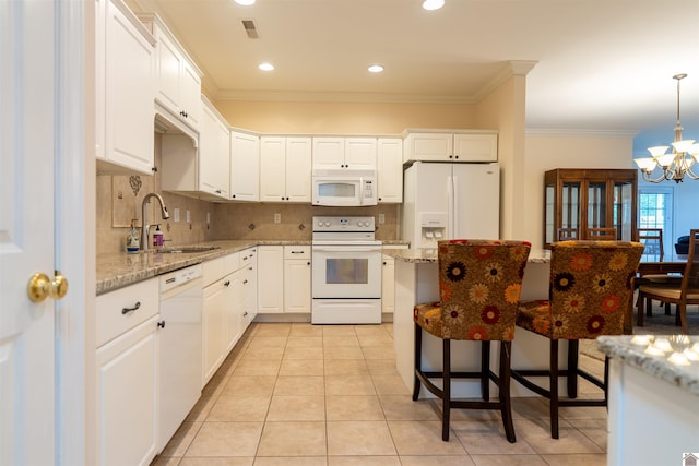 2492 Lakewood Dr, Paducah, KY 42003 - kitchen featuring white appliances, a sink, a chandelier, ornamental molding, and white cabinetry