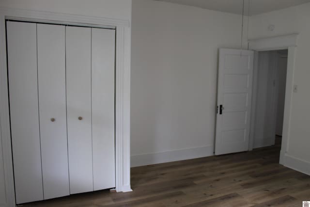 406 S 19, Paducah, KY 42003 - unfurnished bedroom featuring baseboards, a closet, and wood finished floors