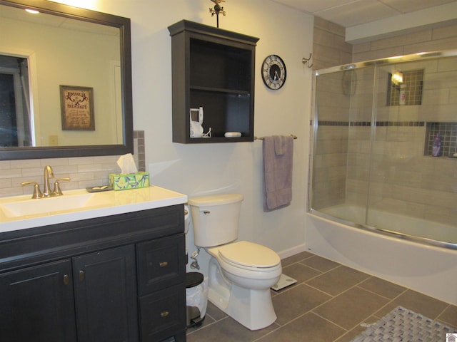 144 Canton Heights 2 Cir, Cadiz, KY 42211 - full bathroom with tile patterned floors, vanity, toilet, bath / shower combo with glass door, and tasteful backsplash