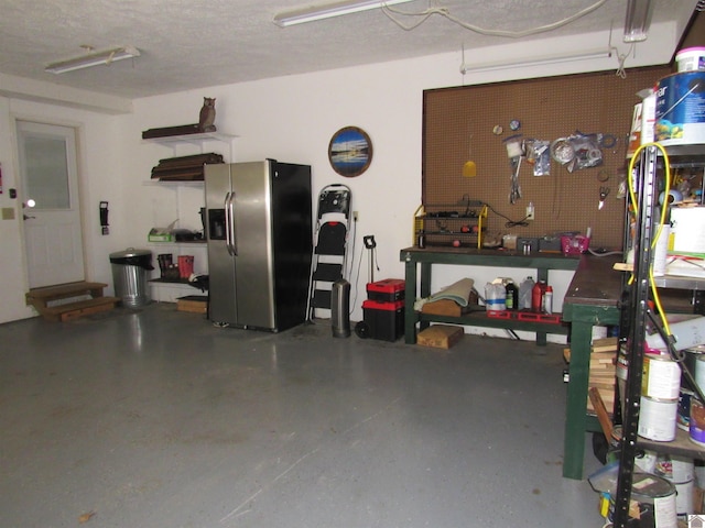 144 Canton Heights 2 Cir, Cadiz, KY 42211 - garage featuring stainless steel fridge with ice dispenser and a workshop area