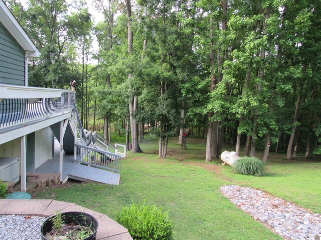 144 Canton Heights 2 Cir, Cadiz, KY 42211 - view of grassy yard with a deck, an outdoor fire pit, and view of wooded area