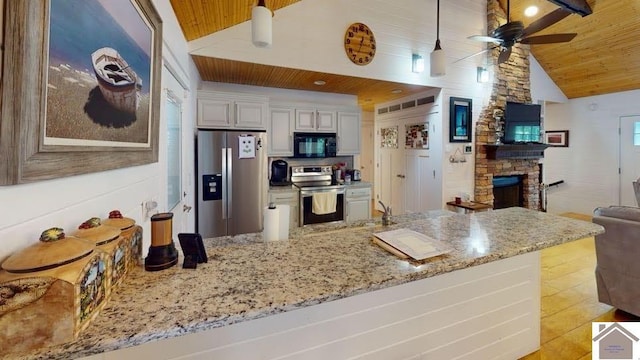 144 Canton Heights 2 Cir, Cadiz, KY 42211 - kitchen featuring stainless steel appliances, wooden ceiling, a ceiling fan, a fireplace, and light stone countertops