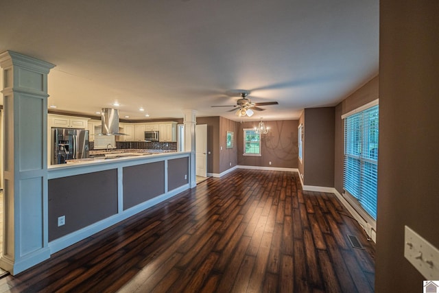 3561 Beal, Hardin, KY 42048 - kitchen with appliances with stainless steel finishes, island exhaust hood, backsplash, light countertops, and dark wood-style flooring