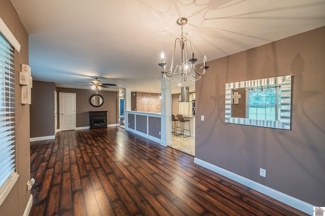 3561 Beal, Hardin, KY 42048 - unfurnished living room with ceiling fan, baseboards, hardwood / wood-style floors, a chandelier, and a fireplace