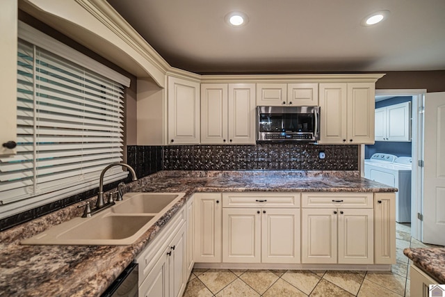 3561 Beal, Hardin, KY 42048 - kitchen featuring stainless steel microwave, washer and dryer, tasteful backsplash, recessed lighting, and dark stone counters
