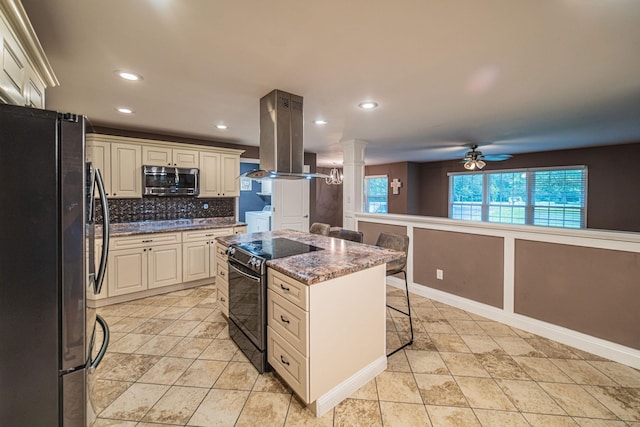 3561 Beal, Hardin, KY 42048 - kitchen with freestanding refrigerator, electric range, decorative columns, island exhaust hood, and stainless steel microwave
