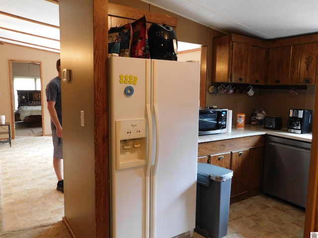 920 State Route 506, Marion, KY 42064 - kitchen featuring white fridge with ice dispenser, black microwave, light countertops, and light floors