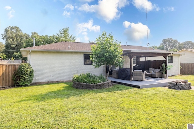 2145 Blankenship, Paducah, KY 42003 - back of house with an outdoor living space with a fire pit, brick siding, a fenced backyard, and a patio area