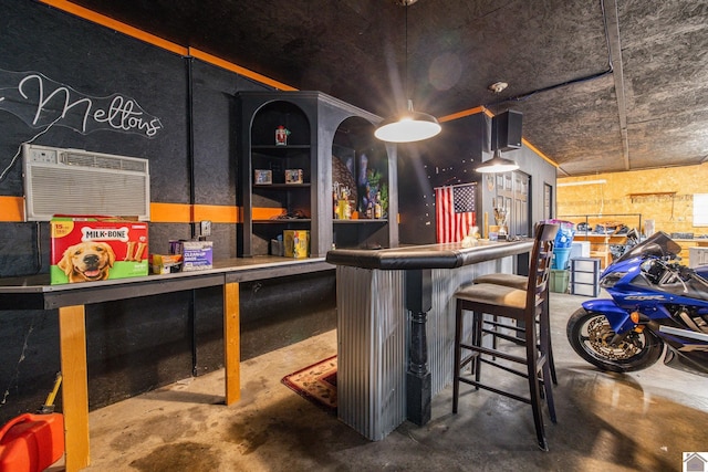 2145 Blankenship, Paducah, KY 42003 - indoor dry bar with unfinished concrete floors and a wall mounted air conditioner