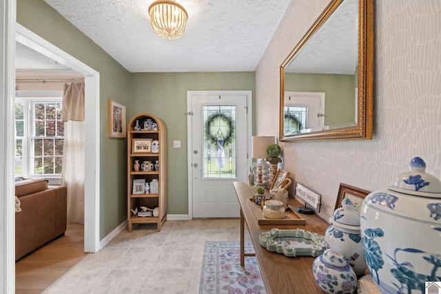 2145 Blankenship, Paducah, KY 42003 - entrance foyer with plenty of natural light, a textured ceiling, and a chandelier
