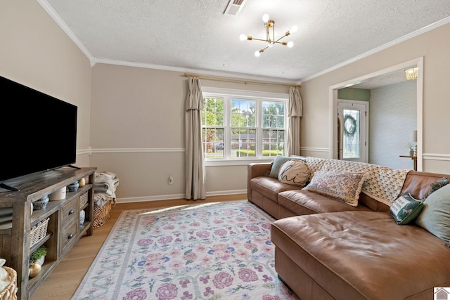 2145 Blankenship, Paducah, KY 42003 - living area featuring a chandelier, ornamental molding, light wood finished floors, and a textured ceiling