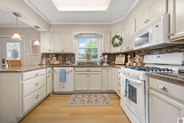 2145 Blankenship, Paducah, KY 42003 - kitchen featuring white appliances, light wood-style flooring, a peninsula, backsplash, and dark stone counters