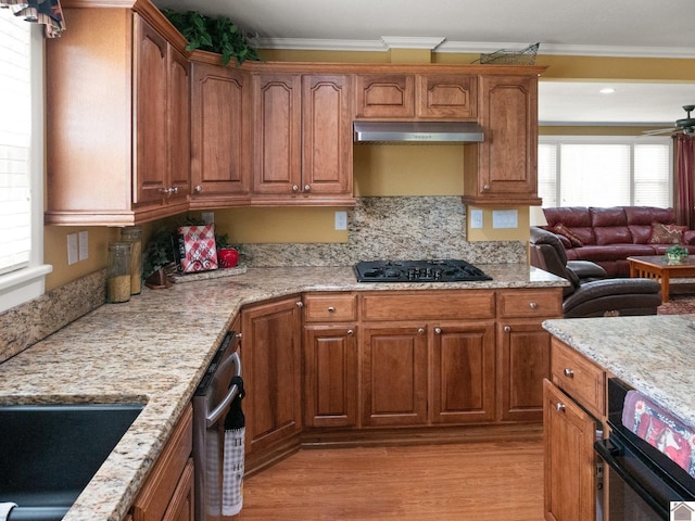 2488 Cypress Trl, New Concord, KY 42076 - kitchen featuring black gas cooktop, light wood-type flooring, crown molding, light stone countertops, and open floor plan