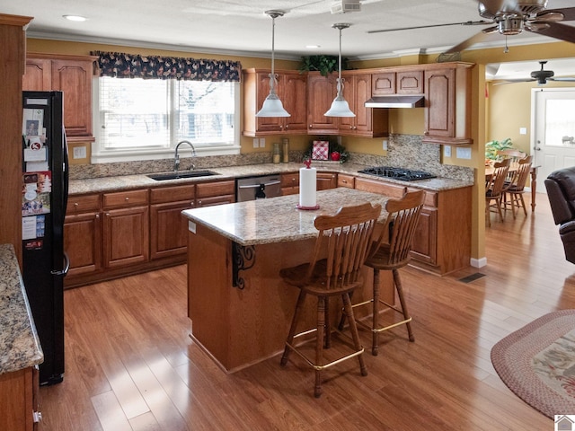 2488 Cypress Trl, New Concord, KY 42076 - kitchen featuring black appliances, healthy amount of natural light, a ceiling fan, brown cabinets, and crown molding