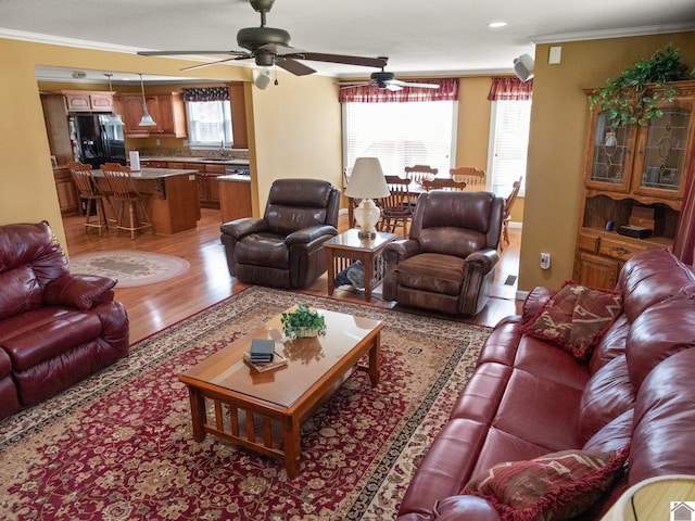 2488 Cypress Trl, New Concord, KY 42076 - living room with light wood-style flooring, ceiling fan, and crown molding