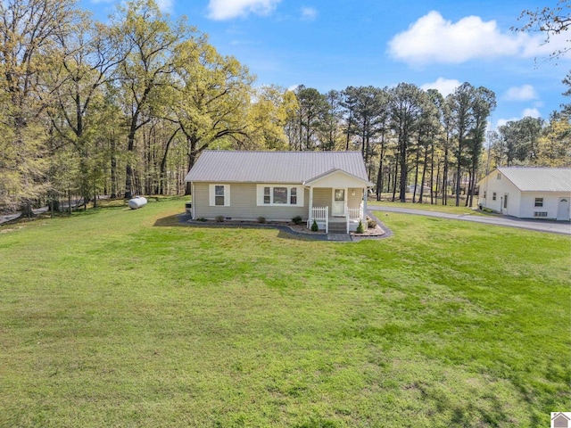 2488 Cypress Trl, New Concord, KY 42076 - back of property with a porch, a yard, and a metal roof