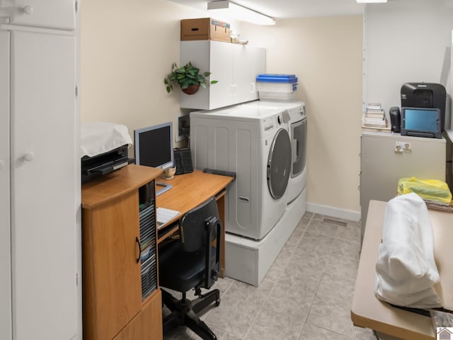 2488 Cypress Trl, New Concord, KY 42076 - laundry area with washing machine and clothes dryer, a desk, cabinet space, and light tile patterned floors