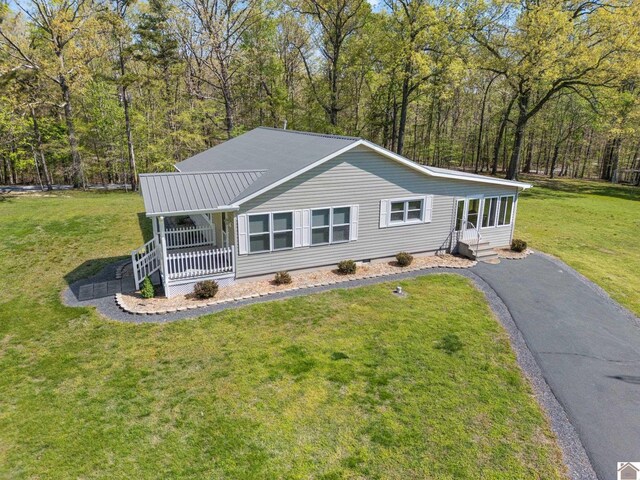 2488 Cypress Trl, New Concord, KY 42076 - view of front of home with covered porch, a front lawn, asphalt driveway, crawl space, and a forest view